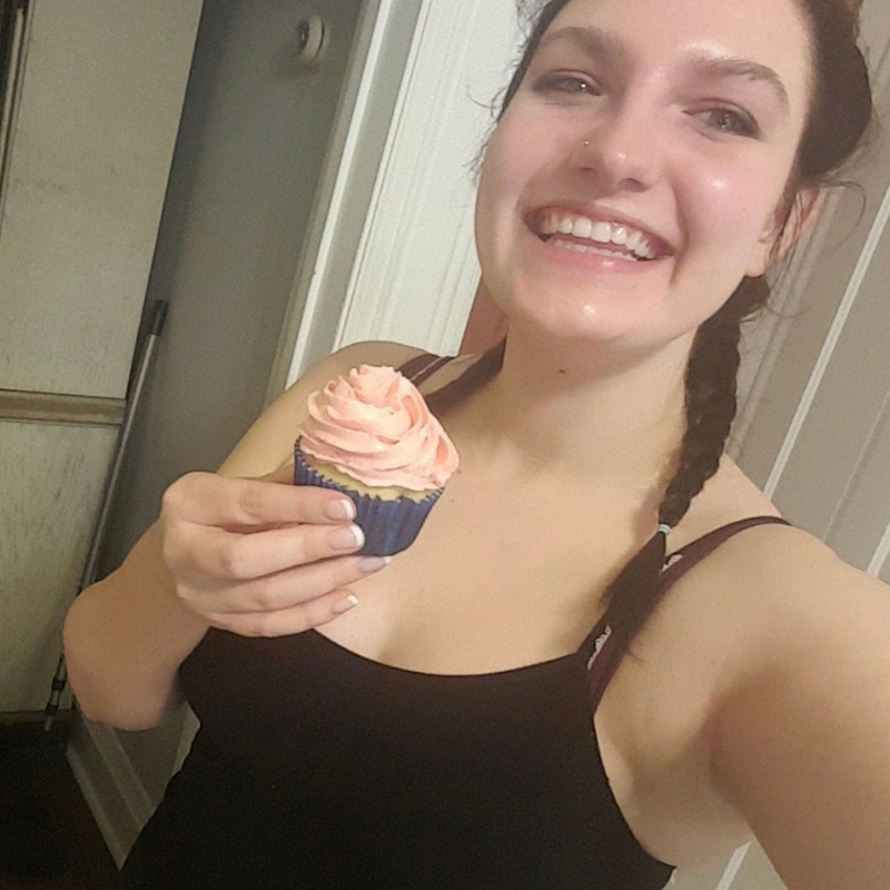 Hidden Talents - Carolyn Smiling and Holding a Cupcake