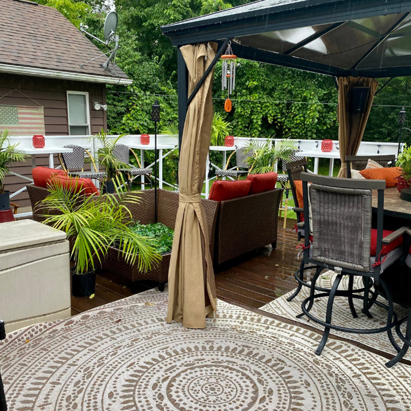 Hidden Talents - Chairs, Gazebo, a Table, and a Round Rug on Outdoor Deck