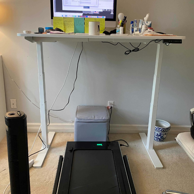 Hidden Talents - Computer and Papers on Desk With Treadmill