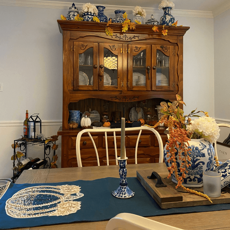 Favorite Things About Fall - Dining Room Table and China Closet Decorated with Fall Leaves