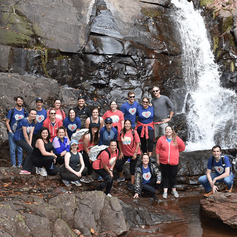 Group Photo of Team Members at Waterfall